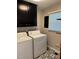 Laundry area with washer, dryer, and unique patterned flooring at 1418 Sherron Rd, Durham, NC 27703