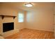Bright empty living room features a brick fireplace, hardwood floors, and lots of light at 1418 Sherron Rd, Durham, NC 27703