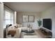 Bright living room with neutral palette, contemporary furnishings, and ample natural light at 1418 Sherron Rd, Durham, NC 27703