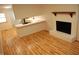 Open concept kitchen counter into living area with fireplace and light hardwood floors at 1418 Sherron Rd, Durham, NC 27703