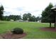 Expansive lawn is highlighted, perfect for outdoor activities, with the home and adjacent properties creating a serene landscape at 1418 Sherron Rd, Durham, NC 27703
