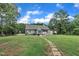 Well-maintained backyard with stone pathway leading to the home at 152 Abundant Ave, Angier, NC 27501