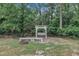 Relaxing backyard with swing set, fire pit, and shaded area at 152 Abundant Ave, Angier, NC 27501