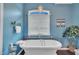 Serene bathroom with a freestanding tub under a window and a hanging chandelier at 152 Abundant Ave, Angier, NC 27501