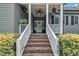 Close-up of charming front porch and brick stairs that lead to a front door at 152 Abundant Ave, Angier, NC 27501