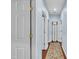 Hallway boasts hardwood floors, fresh paint, and multiple doors for easy access at 152 Abundant Ave, Angier, NC 27501
