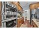 Modern kitchen featuring stainless steel appliances, granite counters, and warm wood cabinetry at 152 Abundant Ave, Angier, NC 27501