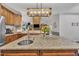 Open kitchen with granite island overlooking the living room, perfect for entertaining guests at 152 Abundant Ave, Angier, NC 27501