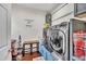 Bright laundry room features modern washer and dryer, storage, and stylish decor at 152 Abundant Ave, Angier, NC 27501