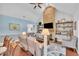 Bright living room featuring a stone fireplace, custom shelving, and comfortable seating area at 152 Abundant Ave, Angier, NC 27501