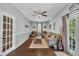 Bright living room with hardwood floors, a ceiling fan, and access to the outdoors at 152 Abundant Ave, Angier, NC 27501