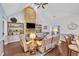 Spacious living room boasts a striking stone fireplace, built-in bookshelves and wood flooring at 152 Abundant Ave, Angier, NC 27501