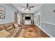 Comfortable living room with hardwood floors, a large sofa, and a stylish entertainment center at 152 Abundant Ave, Angier, NC 27501
