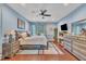 Spacious main bedroom featuring blue walls, ceiling fan, with bedside tables and dressers at 152 Abundant Ave, Angier, NC 27501