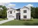 Charming two-story home boasts classic white siding, stone accents, and a well-manicured lawn at 167 Yellow River Way, Garner, NC 27529