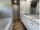 Modern bathroom features double vanities, granite countertops and a separate tub at 168 Oakfield Trace Dr, Four Oaks, NC 27524