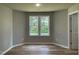 Sunlit bedroom with large windows and hardwood floors at 168 Oakfield Trace Dr, Four Oaks, NC 27524