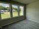 Carpeted bedroom showcases natural light, view of neighborhood and neutral paint for easy customization at 168 Oakfield Trace Dr, Four Oaks, NC 27524