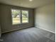 Inviting, light-filled bedroom features plush carpet and view of the neighborhood through double windows at 168 Oakfield Trace Dr, Four Oaks, NC 27524
