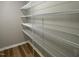 Walk-in closet features built-in shelving for organized storage at 168 Oakfield Trace Dr, Four Oaks, NC 27524