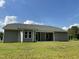 View of the house's exterior back shows the ample backyard, siding and windows at 168 Oakfield Trace Dr, Four Oaks, NC 27524