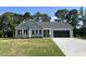 Charming single-story home featuring a well-manicured lawn and a convenient two-car garage at 168 Oakfield Trace Dr, Four Oaks, NC 27524