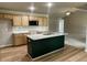 Modern kitchen features a large island with granite countertops and stainless steel appliances at 168 Oakfield Trace Dr, Four Oaks, NC 27524