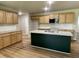 Modern kitchen features a large island with granite countertops and stainless steel appliances at 168 Oakfield Trace Dr, Four Oaks, NC 27524
