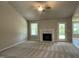 Spacious living room with a fireplace and large windows for natural light at 168 Oakfield Trace Dr, Four Oaks, NC 27524