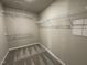 Spacious walk-in closet with installed white wire shelving for maximum storage and organization at 168 Oakfield Trace Dr, Four Oaks, NC 27524