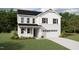 Charming two-story home with a manicured lawn, attached two-car garage, and classic white siding at 180 Sprenger St, Garner, NC 27529