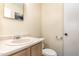 A compact bathroom offers a toilet, sink with vanity, and mirror at 205 Ashley Forest Rd # Bldg D, Chapel Hill, NC 27514