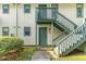 Exterior entrance to condo on a sunny day with green doors at 205 Ashley Forest Rd # Bldg D, Chapel Hill, NC 27514