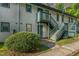 A pleasing two-story condo building features green stairs and light-colored siding at 205 Ashley Forest Rd # Bldg D, Chapel Hill, NC 27514