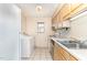 A kitchen with light-colored cabinets, tiled floors, window and stainless steel appliances at 205 Ashley Forest Rd # Bldg D, Chapel Hill, NC 27514