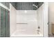 Clean shower space with tub and shower head with patterned wall and neutral accents at 205 Ashley Forest Rd # Bldg D, Chapel Hill, NC 27514