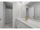 Bright bathroom features a large mirror, white cabinets, and shower with curtain at 211 Forestview Dr, Elon, NC 27244