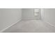 Neutral bedroom with carpet, baseboard trim, and one window bringing in natural light at 211 Forestview Dr, Elon, NC 27244