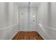 Inviting entryway with hardwood floors, neutral walls, and a solid front door with sidelights at 211 Forestview Dr, Elon, NC 27244