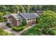 Aerial view of a traditional home with a brick exterior, mature trees, and landscaped yard at 211 Forestview Dr, Elon, NC 27244