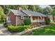 Beautiful home showcasing brick siding, well-manicured landscaping, and a covered front porch at 211 Forestview Dr, Elon, NC 27244