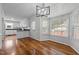 Eat-in kitchen area with modern lighting, hardwood floors, white cabinets, and a view to the outside at 211 Forestview Dr, Elon, NC 27244