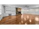 Bright living room with hardwood floors, brick fireplace, built-in shelves, and a ceiling fan at 211 Forestview Dr, Elon, NC 27244