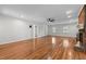 Spacious living room featuring hardwood floors, a brick fireplace, and ample natural light at 211 Forestview Dr, Elon, NC 27244