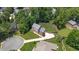 Overhead view of the brick two-story home showing lush green lawn and fenced backyard at 213 Brompton Ct, Burlington, NC 27215
