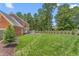 Well-maintained backyard featuring a lush lawn, trees, and a patio at 213 Brompton Ct, Burlington, NC 27215