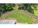 Aerial view of large fenced backyard featuring lush green lawn and landscaping at 213 Brompton Ct, Burlington, NC 27215