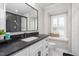 Modern bathroom with dual shower heads, dark countertops, white cabinets, and window seating at 213 Brompton Ct, Burlington, NC 27215