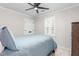 Bedroom features plantation shutters on the window and a blue comforter on the bed at 213 Brompton Ct, Burlington, NC 27215