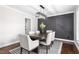 Stylish dining room with a modern light fixture, paneled accent wall, and seating for six at 213 Brompton Ct, Burlington, NC 27215